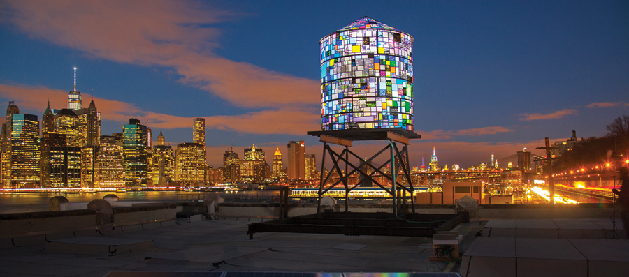 Colorful water tower on top of city building