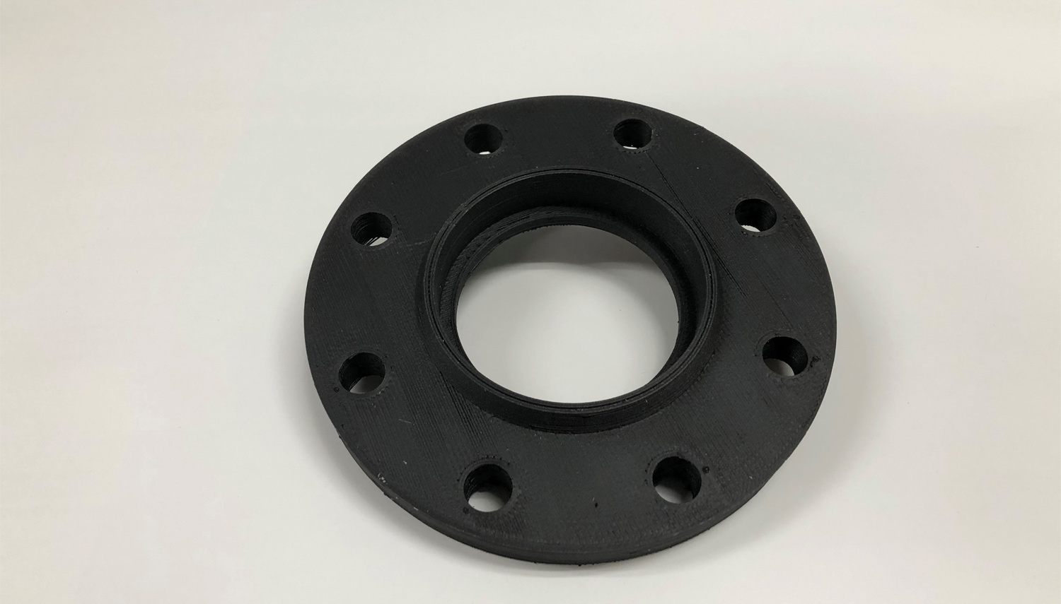 a large flange that has been 3D printed using PVDF filament