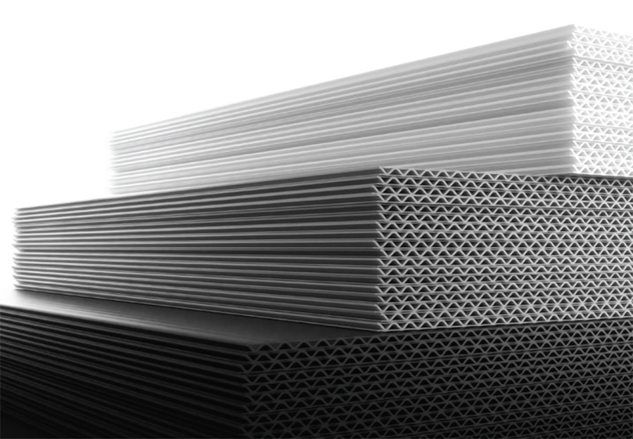 A landscape black and white photograph of plastic sheets stacked on top of each other