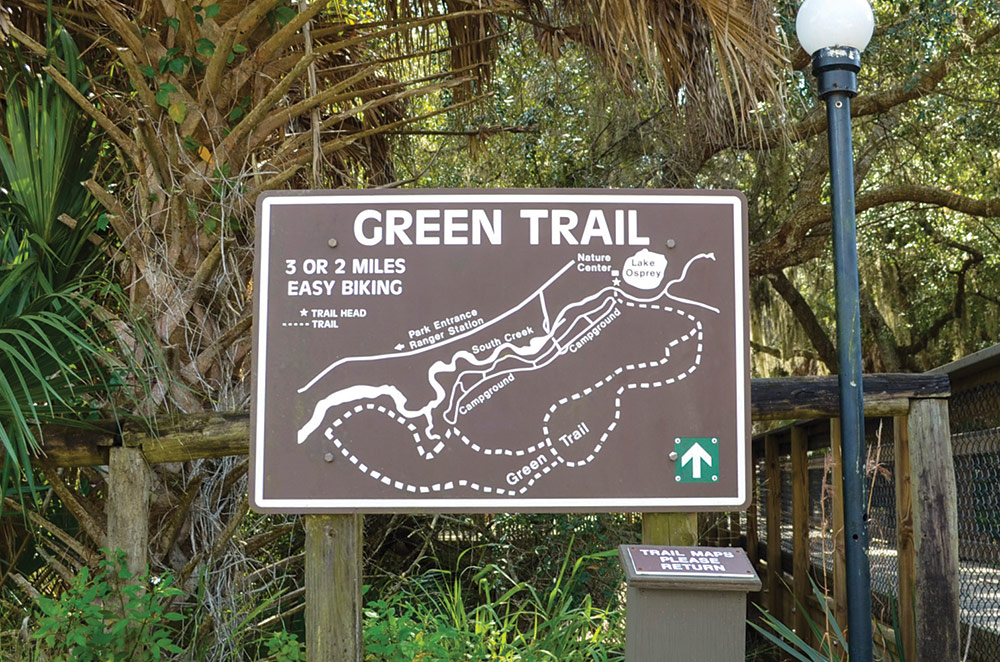 a state park wayfinding sign labeled "Green Trail"