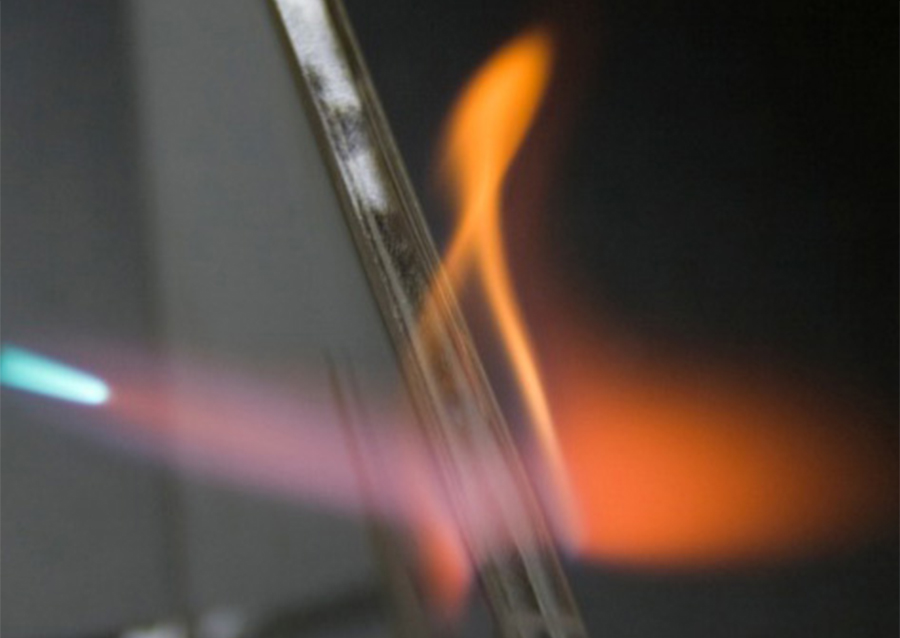closeup of flame being used to polish the edge of plastic