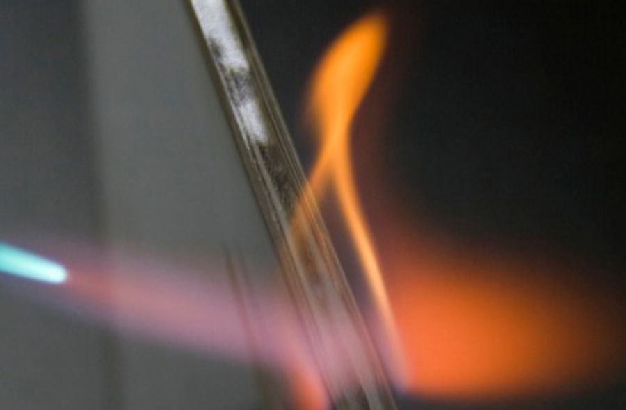 a torch end being held close to plastic material
