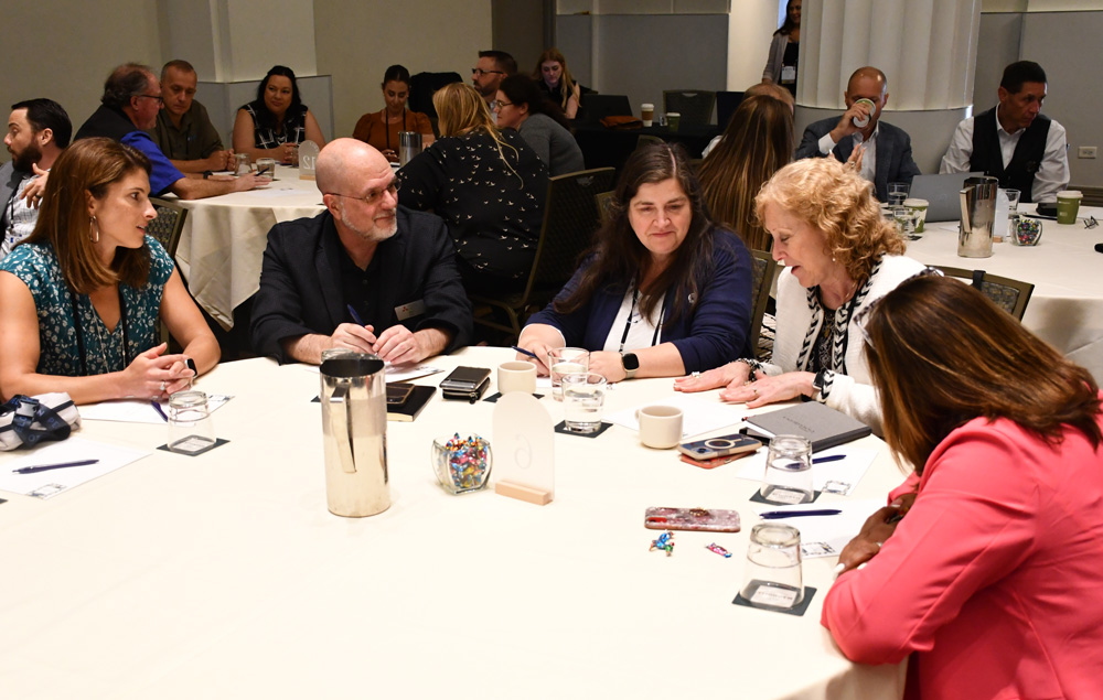 people engaged in a conversation while seated at a table 