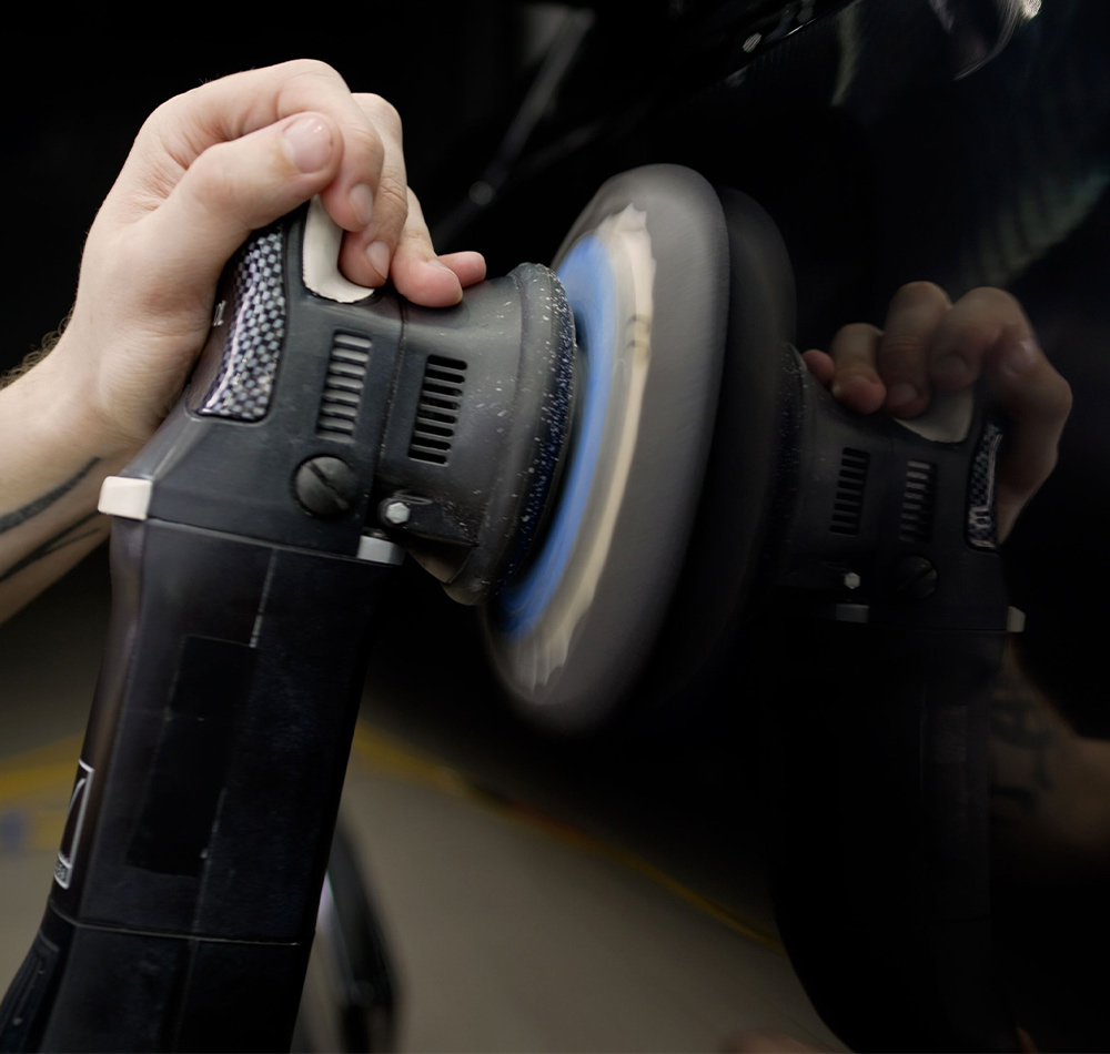 cropped shot of a hand operating an acrylic buffer