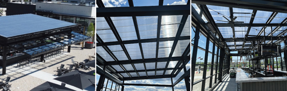 Outdoor commercial bar and seating area with a transparent, motorized folding roof and exposed structural metal beams