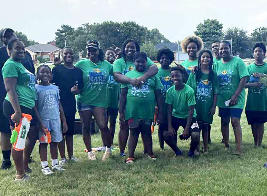 Rachel Chappell with community members wearing matching t-shirts
