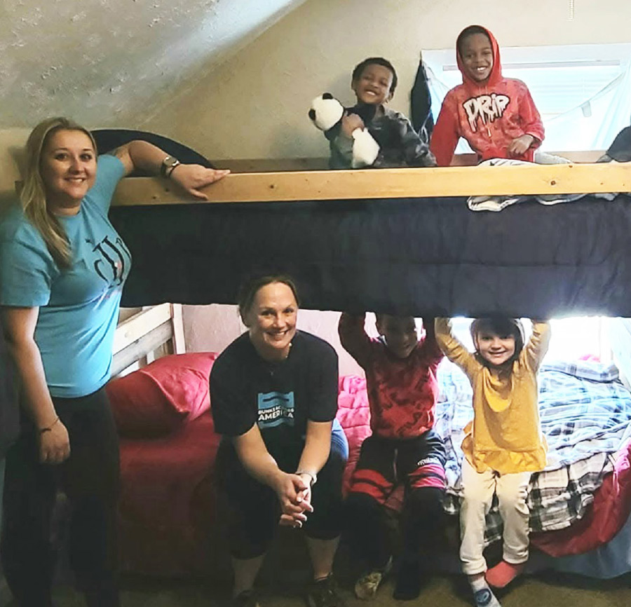 Jessica Joehnk and children on bunk bed she helped build