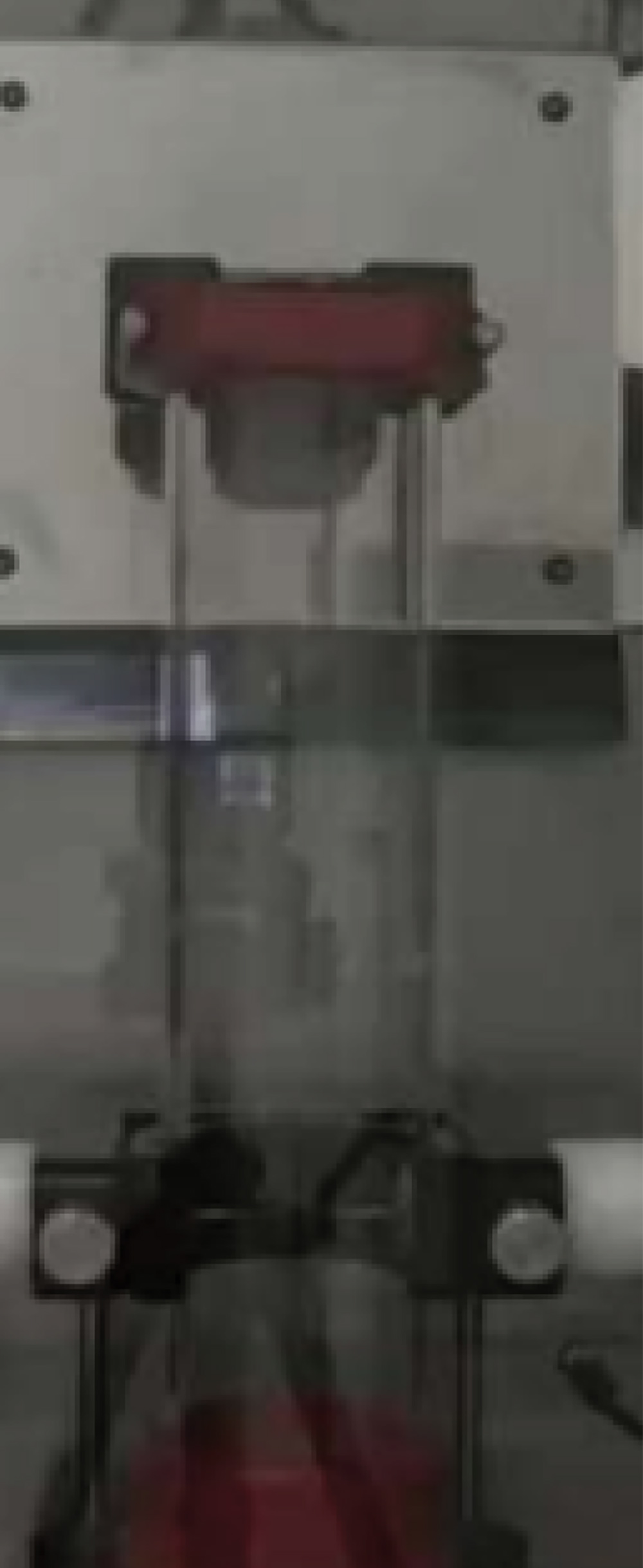 The interior of a laboratory test chamber after a dust ignition trial, showing the vertical apparatus in a dormant state before the next round of safety testing.