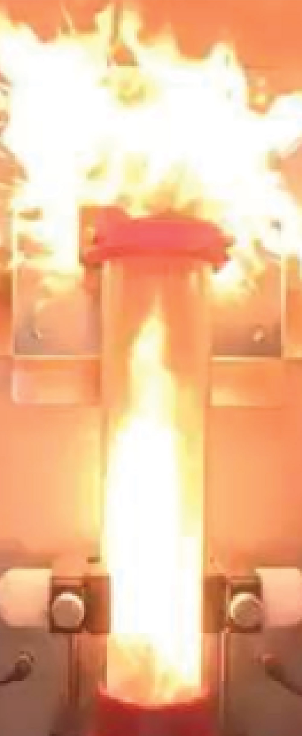 A dramatic laboratory capture of a dust explosion, with bright orange flames and pressure bursting from the top of a vertical test cylinder during a safety trial.