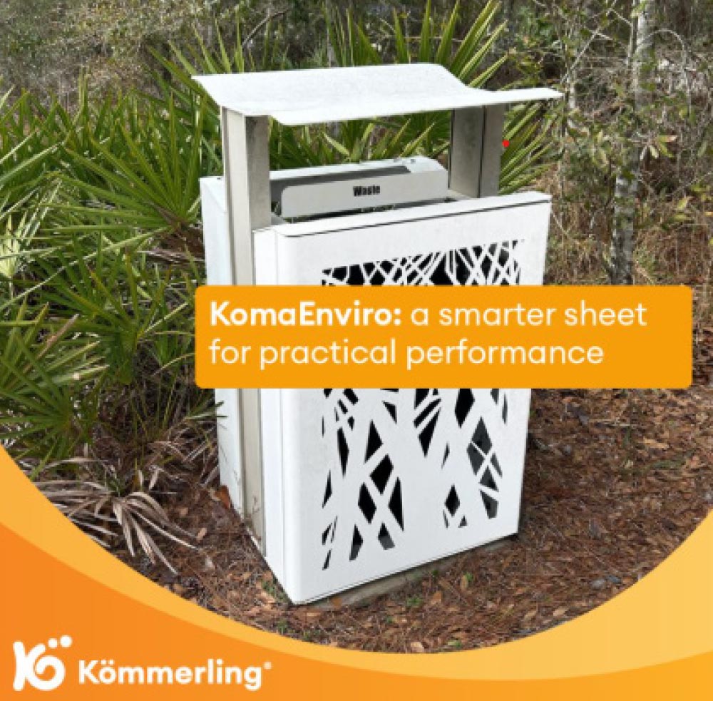 White outdoor waste receptacle with decorative cutouts, surrounded by palmetto plants, overlaid with KomaEnviro text overlay.